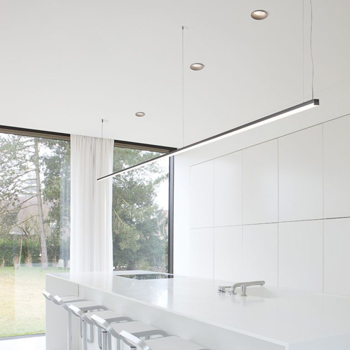 slender pendant lights in a plain white office
