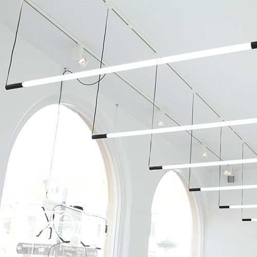 series of thin, bright pendant light bulbs