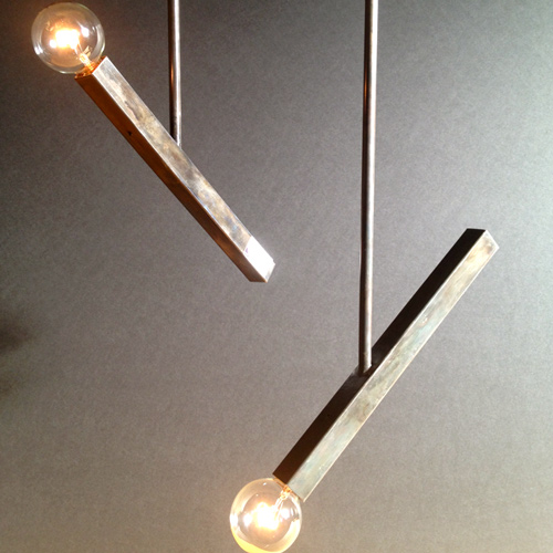 two, torch-designed pendant lights