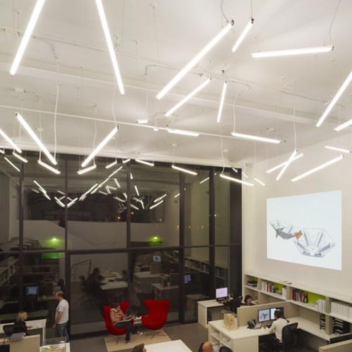 office pals sitting under a diagonal pendant light design